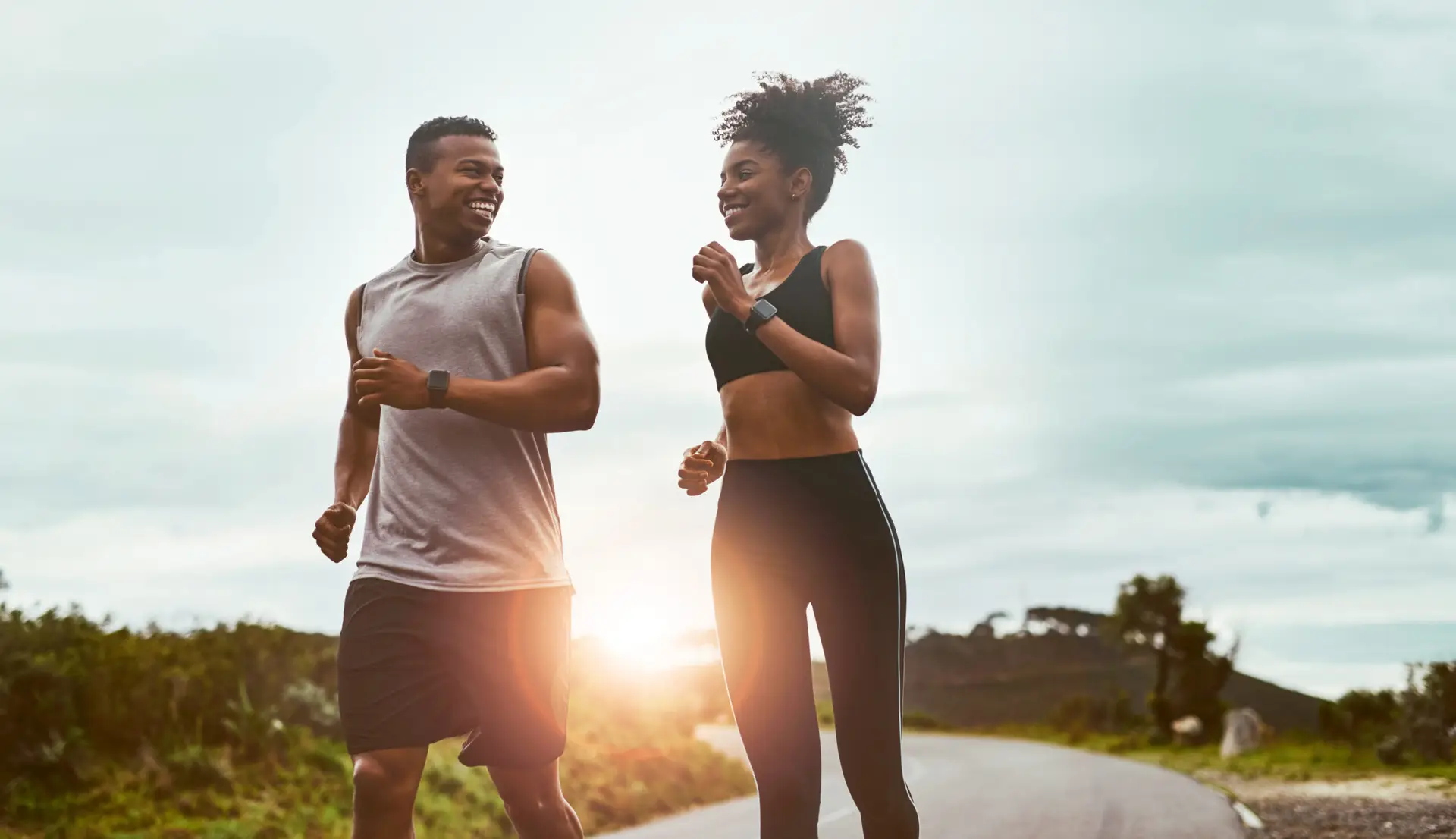 Active couple jogging outdoors representing overall health and wellness